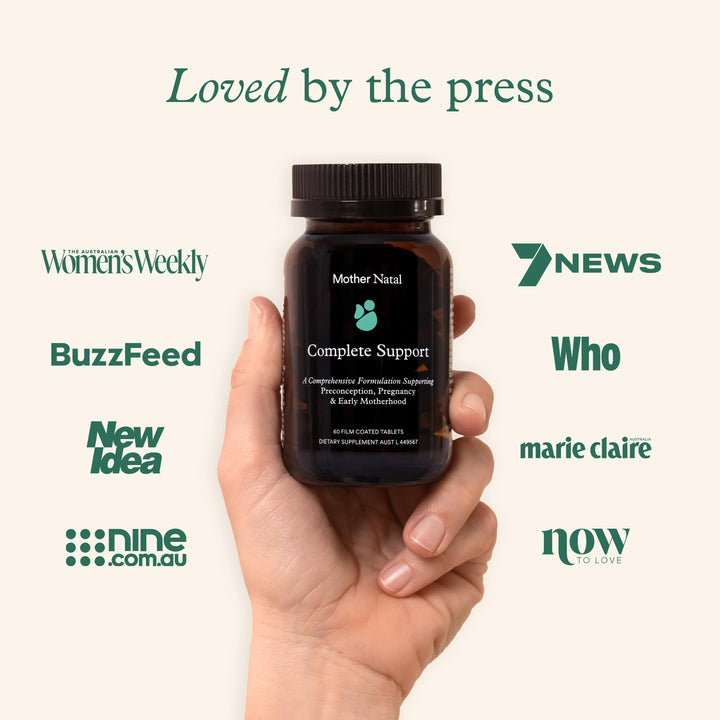 Hand holding a Mother Natal prenatal bottle, surrounded by media logos like BuzzFeed and Marie Claire, highlighting press recognition.
