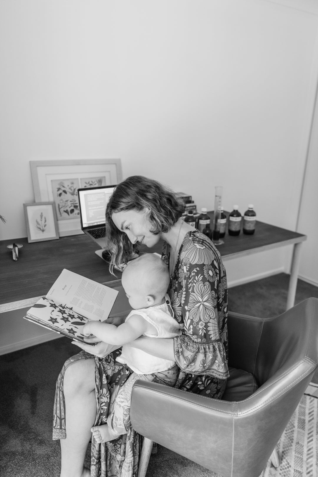 Woman reading to a child in a home office setting