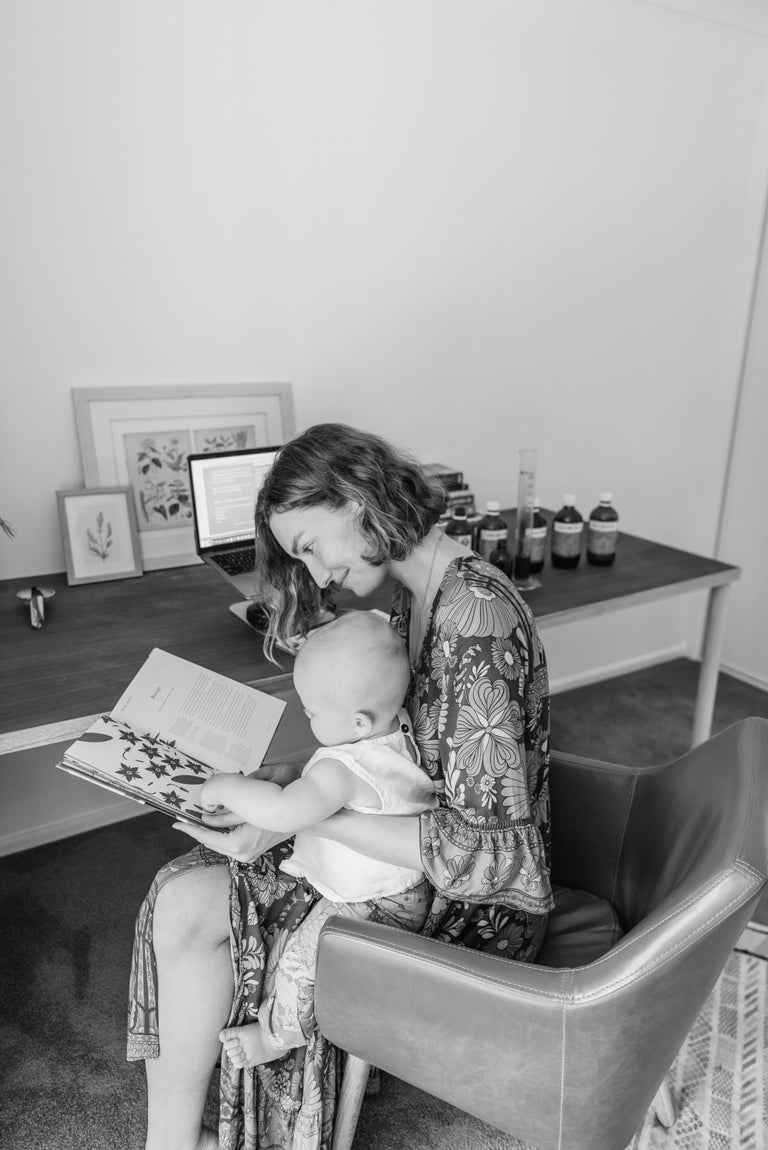 Woman reading to a child in a home office setting